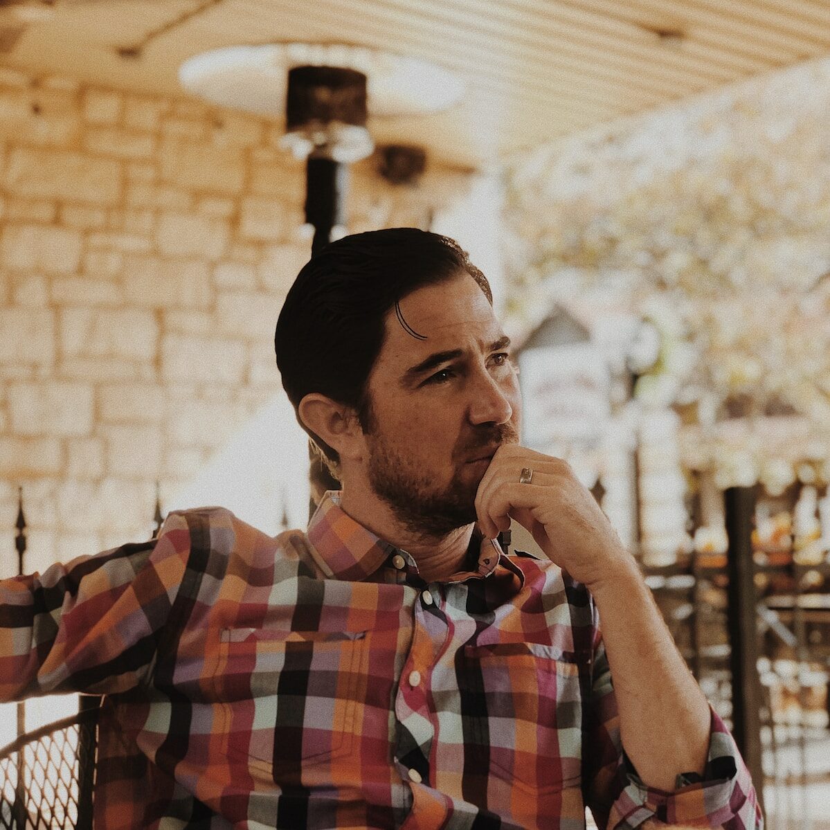 man in red and black plaid dress shirt